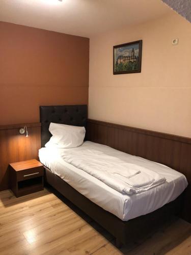 Postel nebo postele na pokoji v ubytování Hotel Poseidon