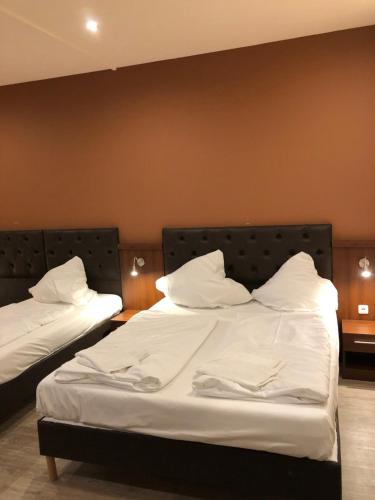 Postel nebo postele na pokoji v ubytování Hotel Poseidon