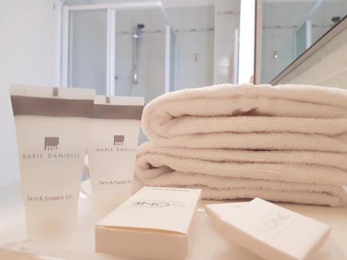 un mucchio di asciugamani su un bancone in bagno di Hotel Ristorante al Giardinetto a Colle Umberto