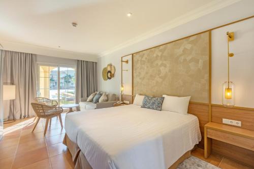 a bedroom with a large bed and a living room at LA SELLA PREMIUM lifestyle Apartments in Denia