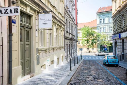 a cobblestone street in a city with a blue car at Miss Sophie's New Town & Wellness in Prague