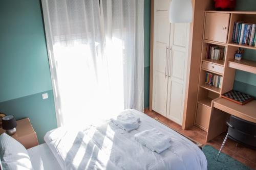 a bedroom with a bed and a book shelf at 4-seasons pool villa near Meteora in Tríkala