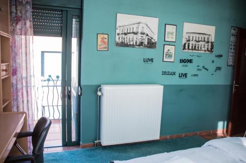 a room with a radiator on a blue wall at 4-seasons pool villa near Meteora in Tríkala