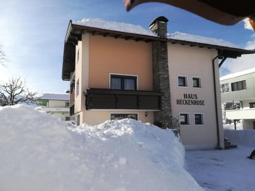 a pile of snow in front of a building at Haus Heckenrose in Westendorf