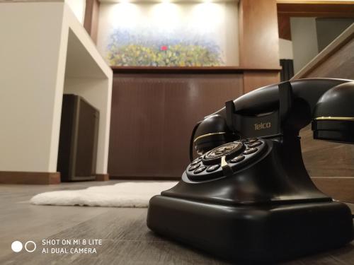 a black telephone sitting on the floor in a room at Oasi in Kato Loutraki