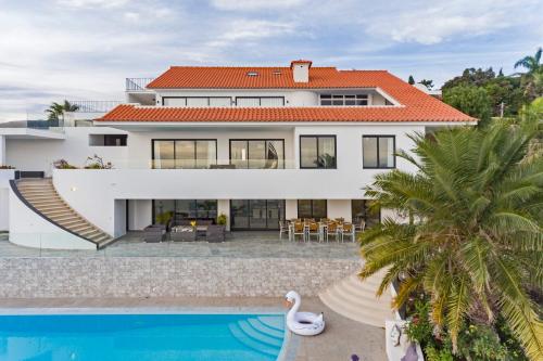 a villa with a swimming pool and a house at Sky Villa by An Island Apart in Funchal