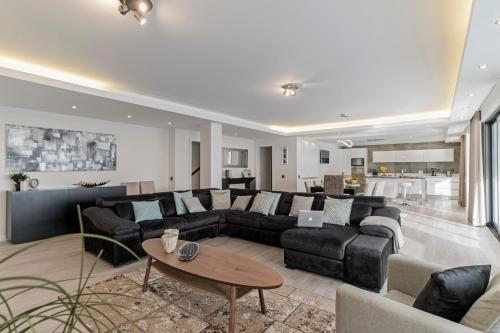 a living room with a couch and a table at Sky Villa by An Island Apart in Funchal