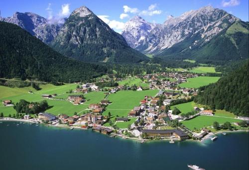 a small town in the middle of a lake with mountains at Haus Miksch in Pertisau