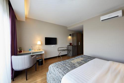 Letto o letti in una camera di San Cristobal Boutique Hotel - Ivato Airport