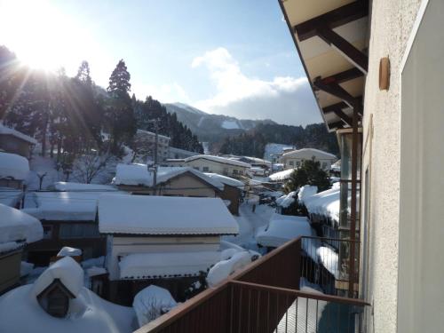 a view from a balcony of a town covered in snow at Yonagoya in Kami