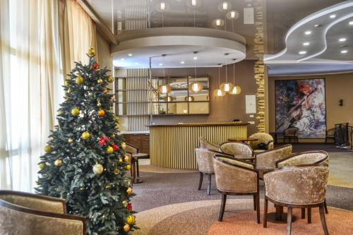 a christmas tree in the lobby of a hotel at Belle Royalle in Lisarnya