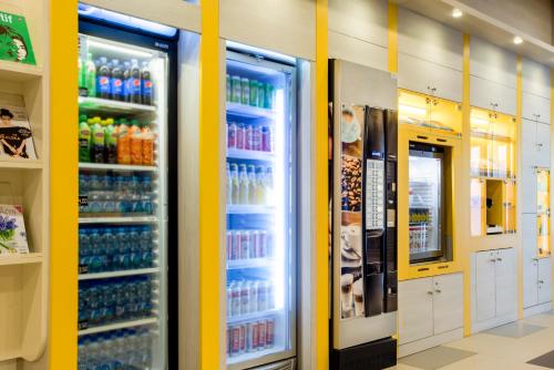 a refrigerator filled with lots of drinks at Premiere Classe Warszawa Centrum in Warsaw