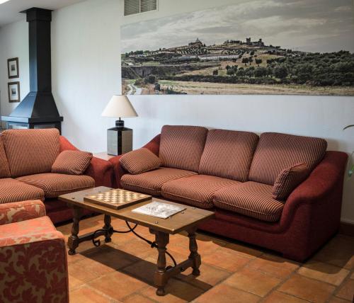 a living room with two couches and a coffee table at Casa Rural Pilón del Fraile in Oropesa