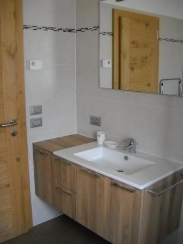 a bathroom with a sink and a mirror at App. Daverda Walter Strada al Plan Dessora 26 in San Vigilio Di Marebbe
