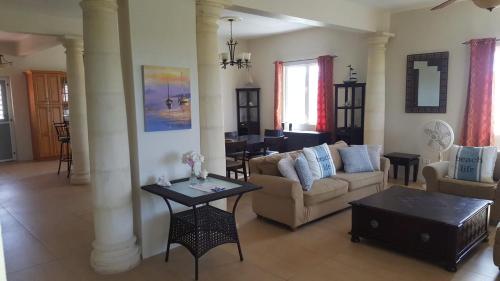 a living room with a couch and a table at White Sands Anguilla - Sea in Blowing Point Village
