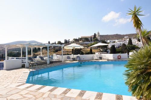 a pool at a hotel with a palm tree at Lefkes Village in Lefkes