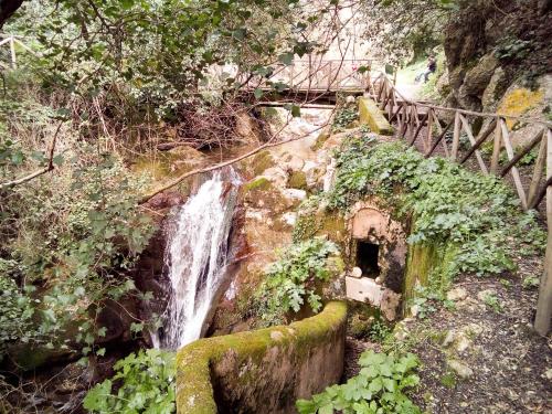 a waterfall on the side of a hill with a bridge at Hotel Grazia Eboli in Eboli