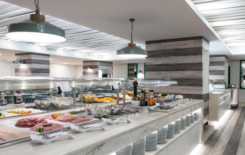 a buffet line with many dishes of food at Hotel Alto Lido in Funchal