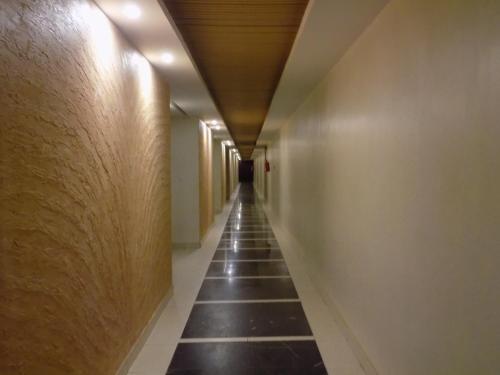 a long corridor with a long hallway at Freedom City Hotel Najjanankumbi Kamapala in Kampala