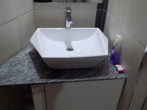 a white sink on a counter in a bathroom at Freedom City Hotel Najjanankumbi Kamapala in Kampala