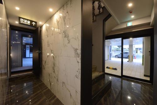 a lobby of a building with a stone wall at Top Motel Busan in Busan