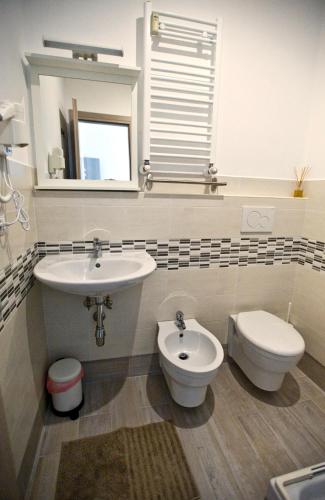 a bathroom with a sink and a toilet and a mirror at Fellini in Rome