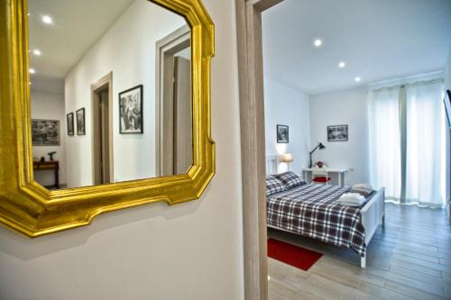 um quarto com uma cama e um espelho na parede em Fellini em Roma