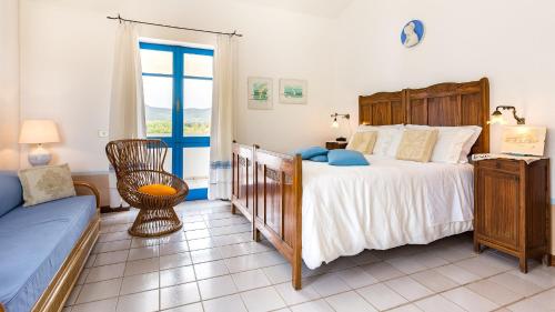 a bedroom with a large bed and a window at Casa Casciu La collina sul mare in Costa Rei