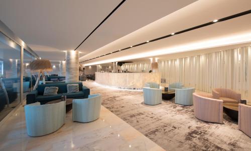 a lobby with couches and tables and a bar at Hotel Alto Lido in Funchal