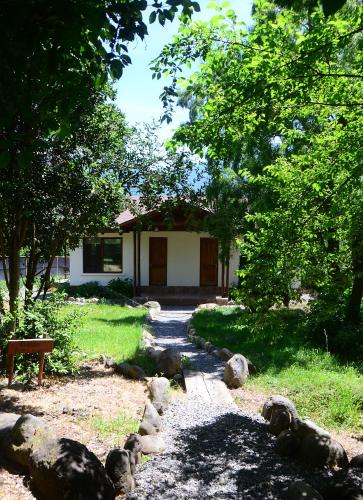 a house with a pathway leading into a yard at Tumuñan Lodge in El Llano