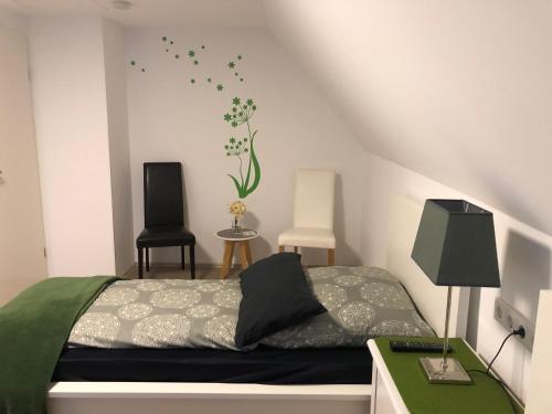 a bedroom with a bed and a desk and a chair at Messezimmer 4u in Düsseldorf