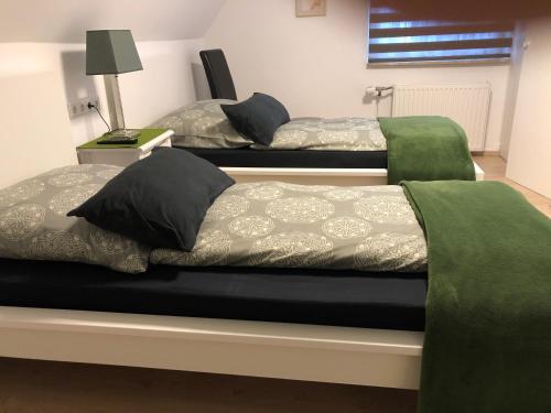 two beds in a room with green and gray at Messezimmer 4u in Düsseldorf