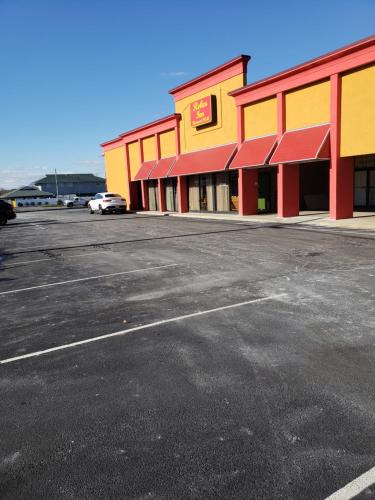 an empty parking lot in front of a store at Relax Inn in Vineland