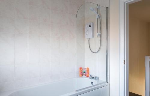 a shower with a glass door in a bathroom at New In Newcastle in Newcastle