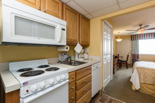 a kitchen with a stove and a microwave at Jade Tree Cove in Myrtle Beach