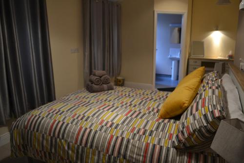 a bed that has a blanket on it at The Arch Accommodation in Carrick-on-Suir