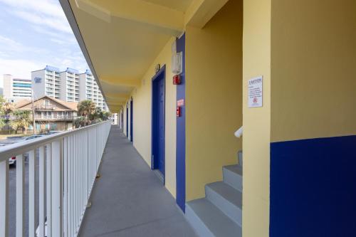 a hallway of a building with blue doors and stairs at Jade Tree Cove in Myrtle Beach