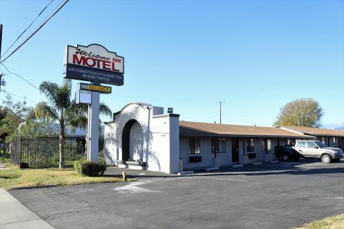 a motel sign in front of a building at Palm Inn Motel - Montclair in Montclair