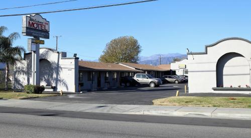 a motel sign on the side of a street at Palm Inn Motel - Montclair in Montclair