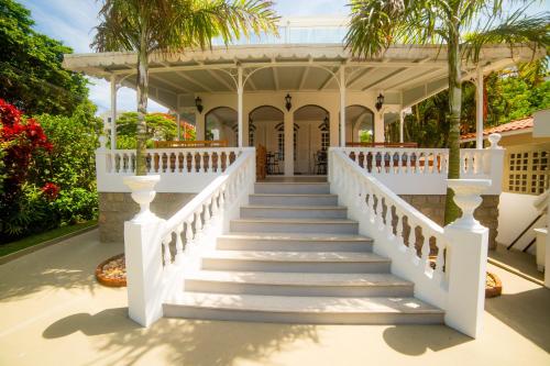 a staircase leading to a house with palm trees at Solar Beach Hotel in Florianópolis