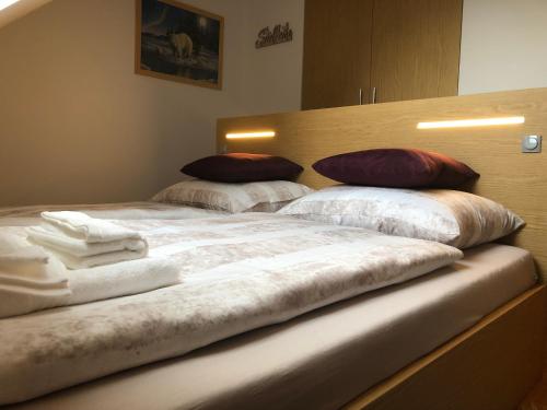 a bed with two pillows on top of it at Apartment MEGI in Kranjska Gora