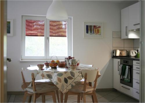 a kitchen with a table and chairs in a room at Gîtes du Tilleul in Niederbronn
