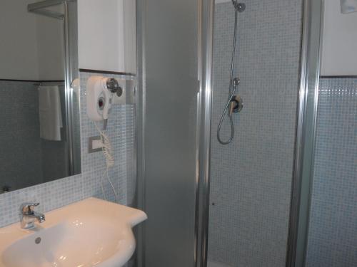 uma casa de banho com um lavatório e um chuveiro em Hotel Diecimare em Cava deʼ Tirreni