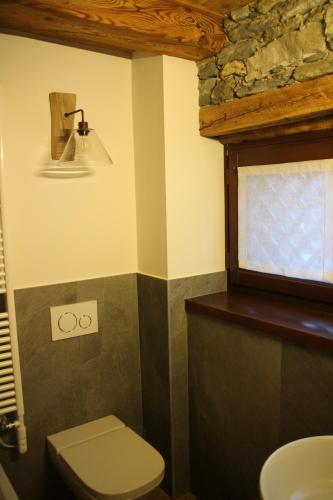 a bathroom with a toilet and a sink at Residence Kalipè in Alagna Valsesia