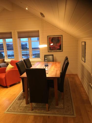 a dining room with a table and chairs at Svinøya, hyggelig leilighet in Svolvær