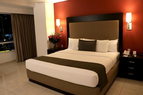 a bedroom with a large bed in a hotel room at Hotel & Suites PF in Mexico City