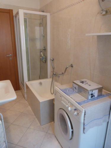 a bathroom with a washing machine and a washer at ASTI LOVELY APARTMENT in Asti