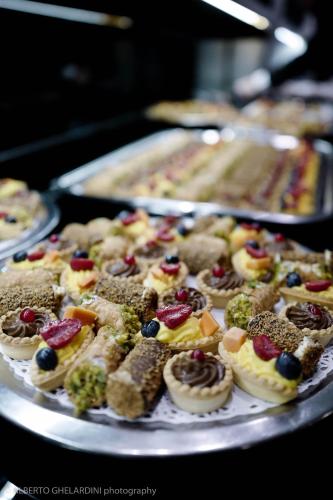 a tray of desserts and pastries on a table at LHP Hotel Montecatini Palace & SPA in Montecatini Terme