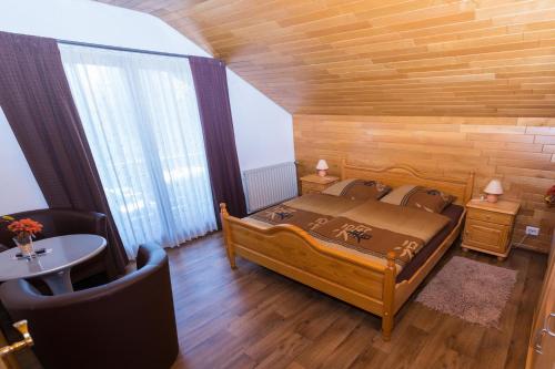 1 dormitorio con 1 cama, mesa y sillas en Hotel Grünes Paradies- Garni, en Hochwaldhausen