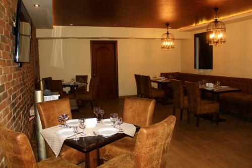 a restaurant with tables and chairs in a room at Argo in Lviv